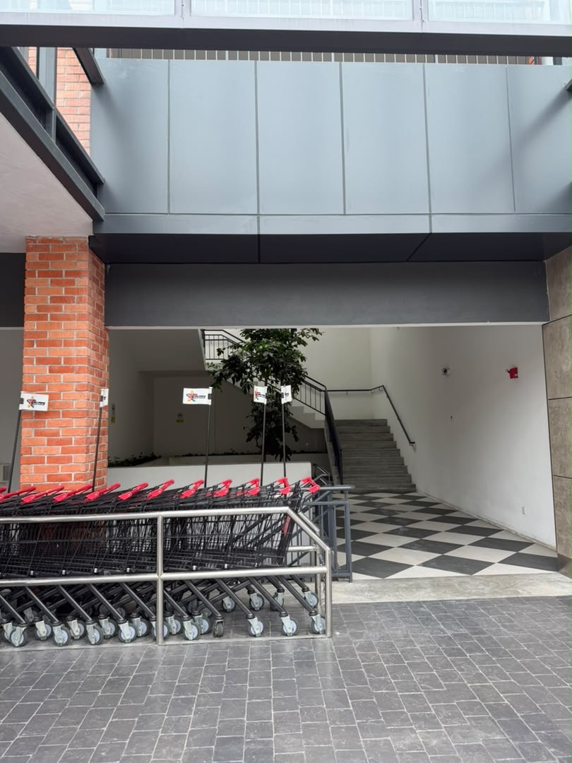 Staircase entrance beside the shopping-trolley bay at Star Grocer